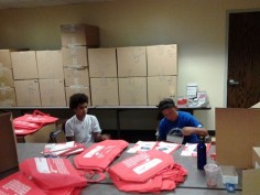 Two young people stuffing St. Fair Bags for MSCOD