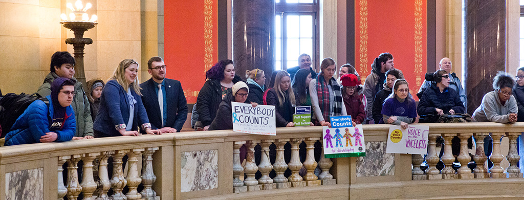 People holding signs at Disability Day 2019