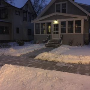 Completely cleared sidewalk in front of a house.