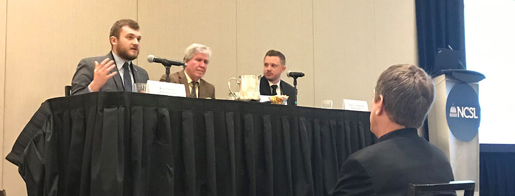 Panel of three people speaking to audience