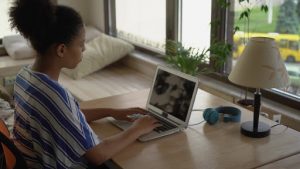 Woman in her home office sitting in front of her laptop.